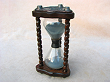 Vintage 3 pillar triangular sand timer with fleur de lis embossed base plates